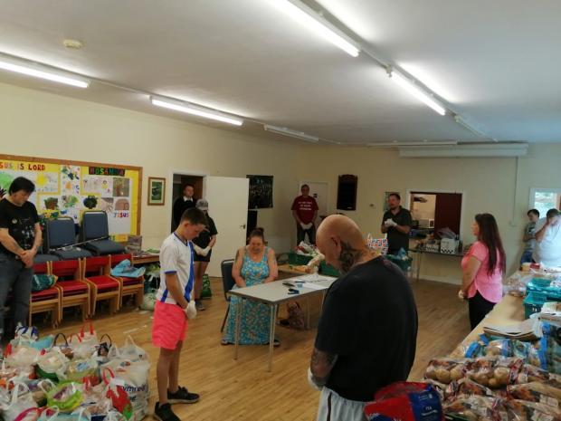 COMMUNITY: Noddfa Church holding a prayer at it’s Food Share hub. Picture: Noddfa Church.