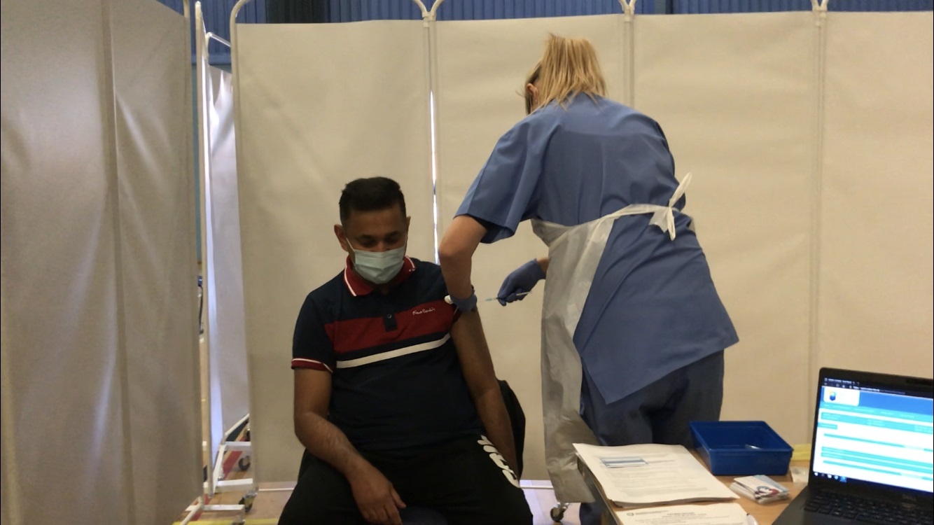 Brynmawr care home worker, Jiji Joseph, receives his coronavirus vaccine in Cwmbran