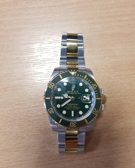 Multi-tone Rolex watch with green face 